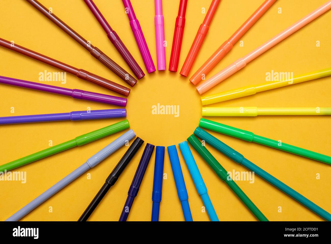 Colored markers on orange background Stock Photo