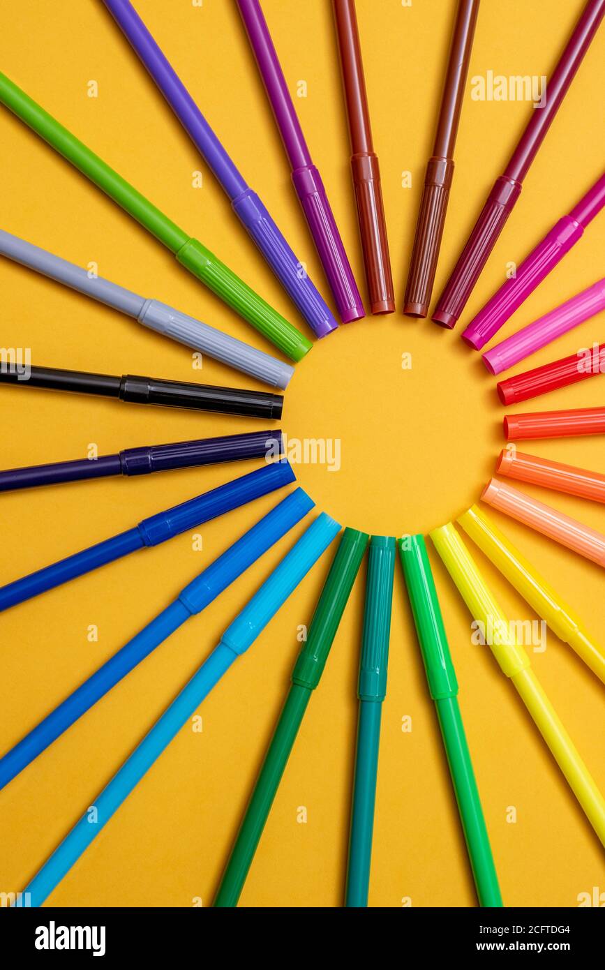 Colored markers on orange background Stock Photo