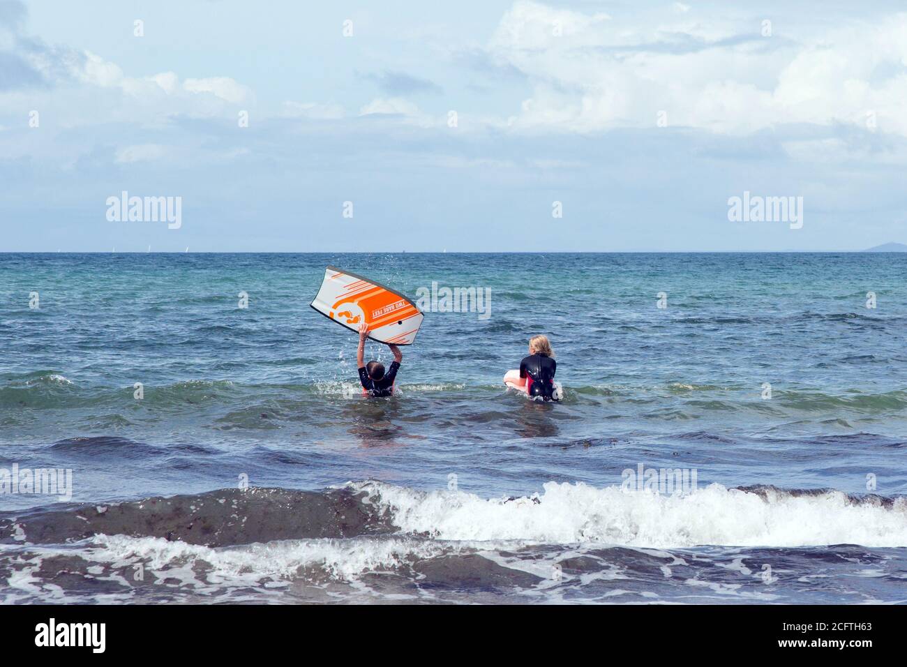 Surfing at Hope Cove beach, Kingsbridge, Devon, England, United Kingdom