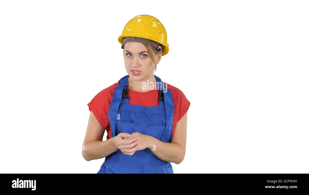 Construction female worket explaining her ideas to camera on white background. Stock Photo