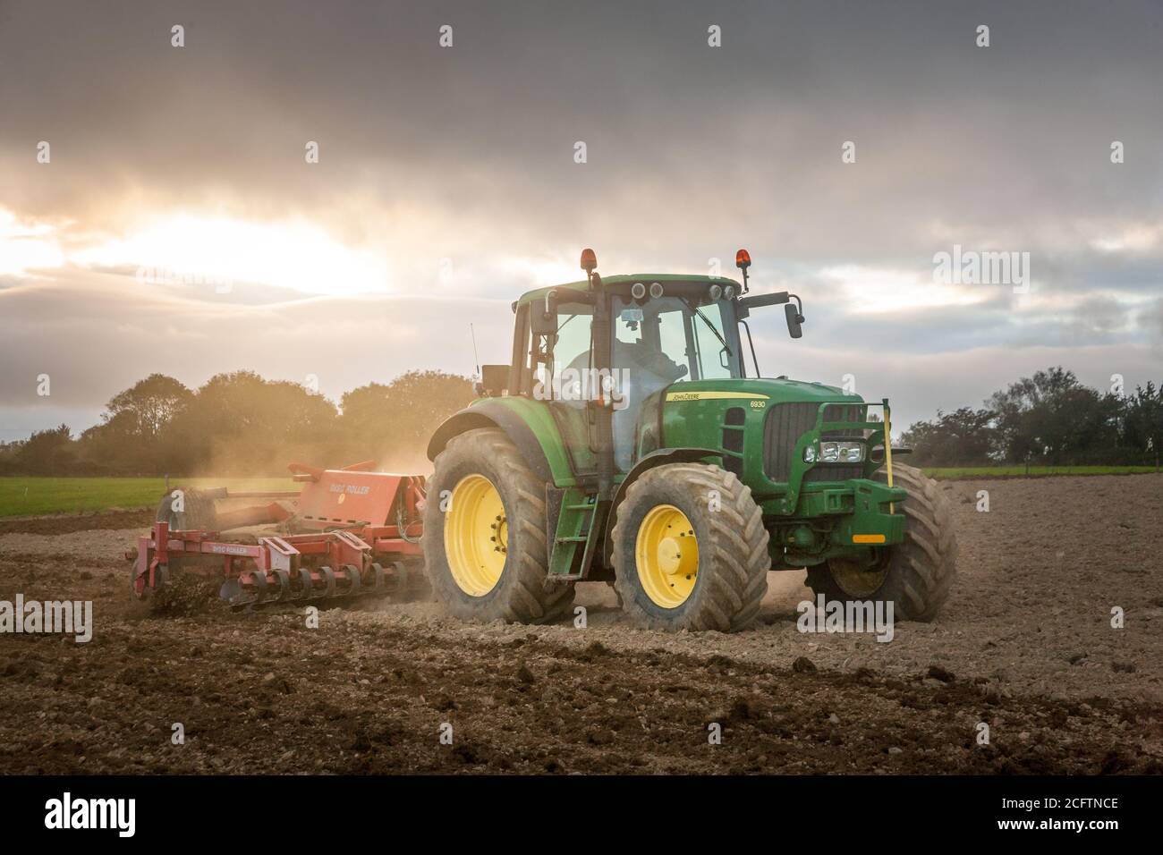 John deere tractor harrowing field hi-res stock photography and images ...