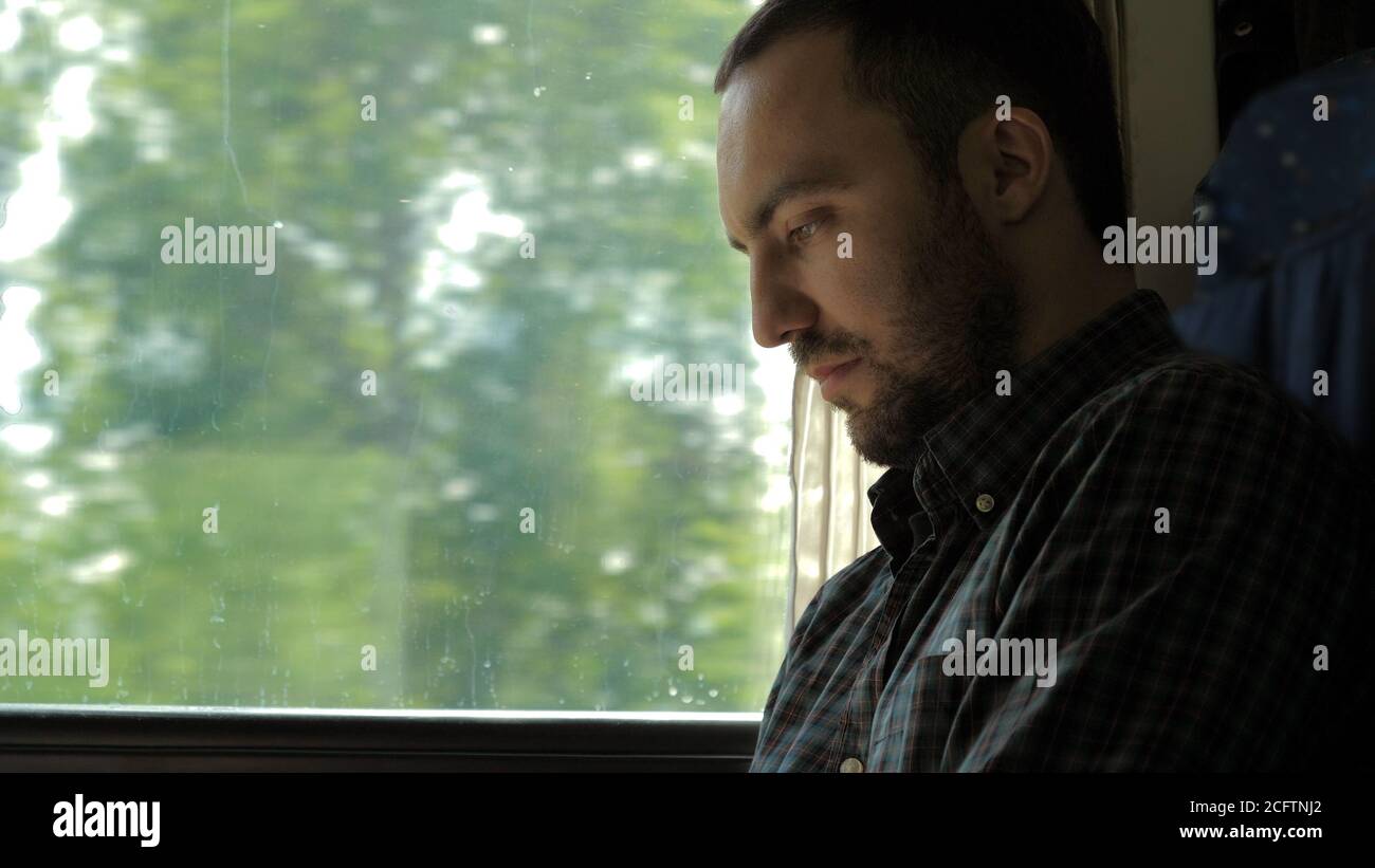 Businessman Commuting On Train Using Digital Tablet. Stock Photo