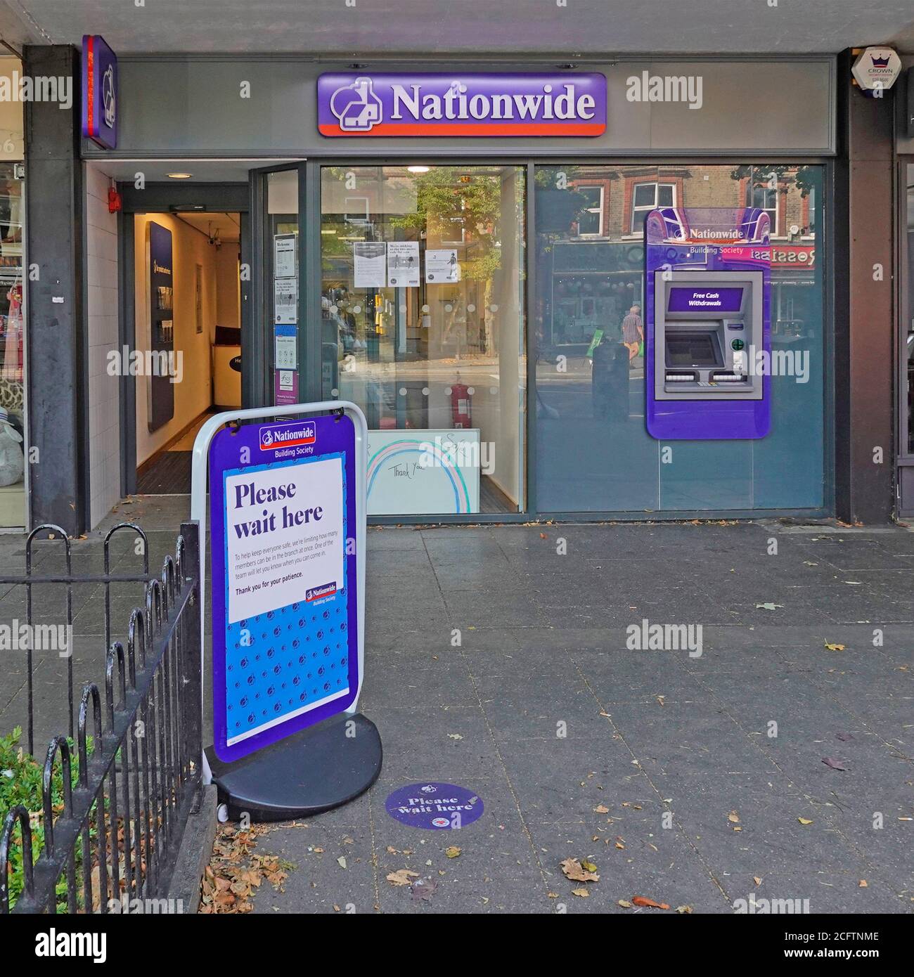 Nationwide Building Society sign outside high street branch premises explains coronavirus covid