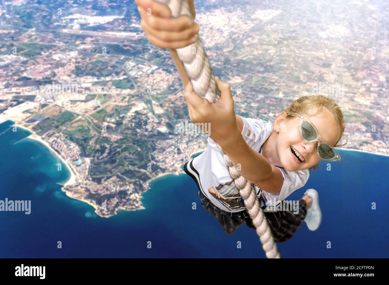 Flying Ropes Girl Flying girl hanging on a rope against the background of seaside Stock ...