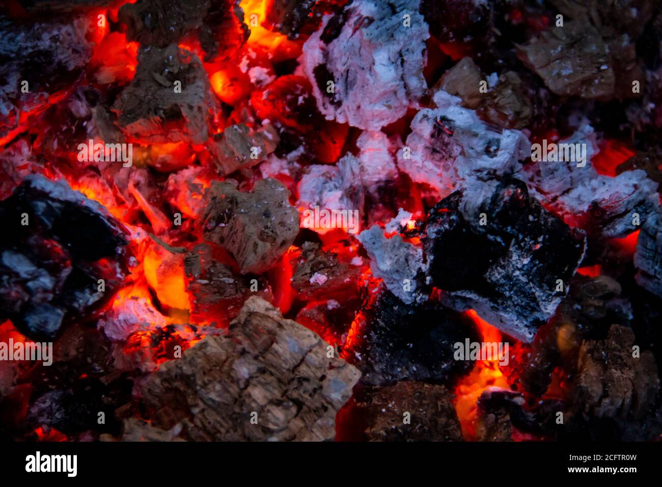 Burning coals. Closeup of decaying charcoal, barbeque season. Bright