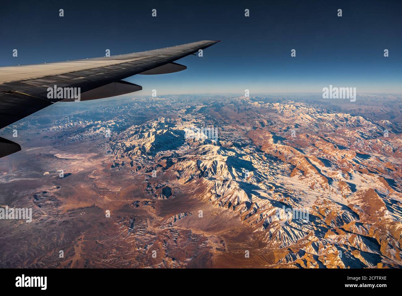 Aerial View from an Airplane. Flying above Beautiful Land at Sunrise. Stock Photo