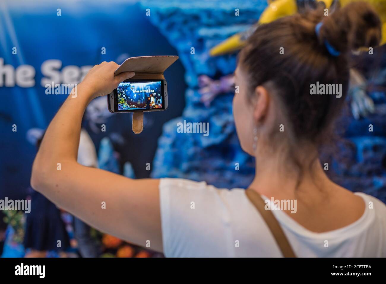 BANGKOK, THAILAND - DECEMBER 16, 2018 - Young Woman Taking Photo of Tales of the Sea Digital Theme Park Entrance on December 16, 2018 in Bangkok, Thai Stock Photo