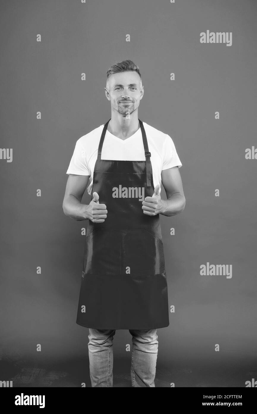 male chef cook in red apron. businessman wear apron in coffee shop. his