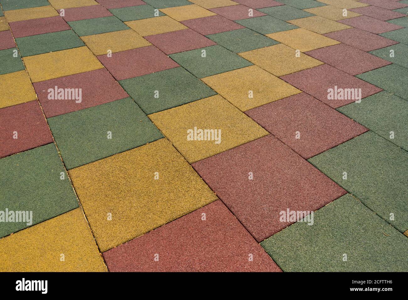 Colored rubber square paving slab for playgrounds closeup Stock Photo