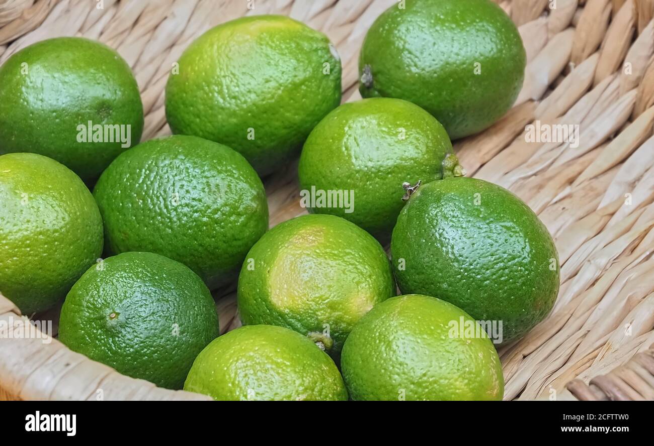 Fresh ripe limes in a basket on a fruit market Stock Photo