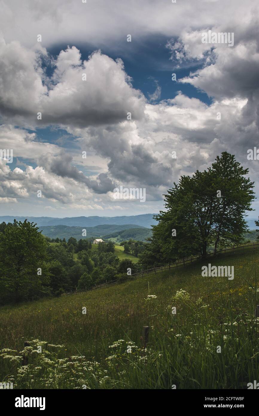 Beautiful shot of a house in a green mountain landscape on a cloudy sky ...