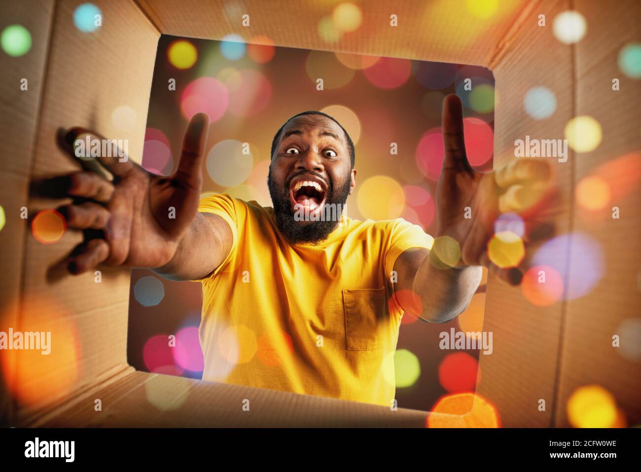 Happy boy receives Christmas gift. happy and surprised expression. Stock Photo