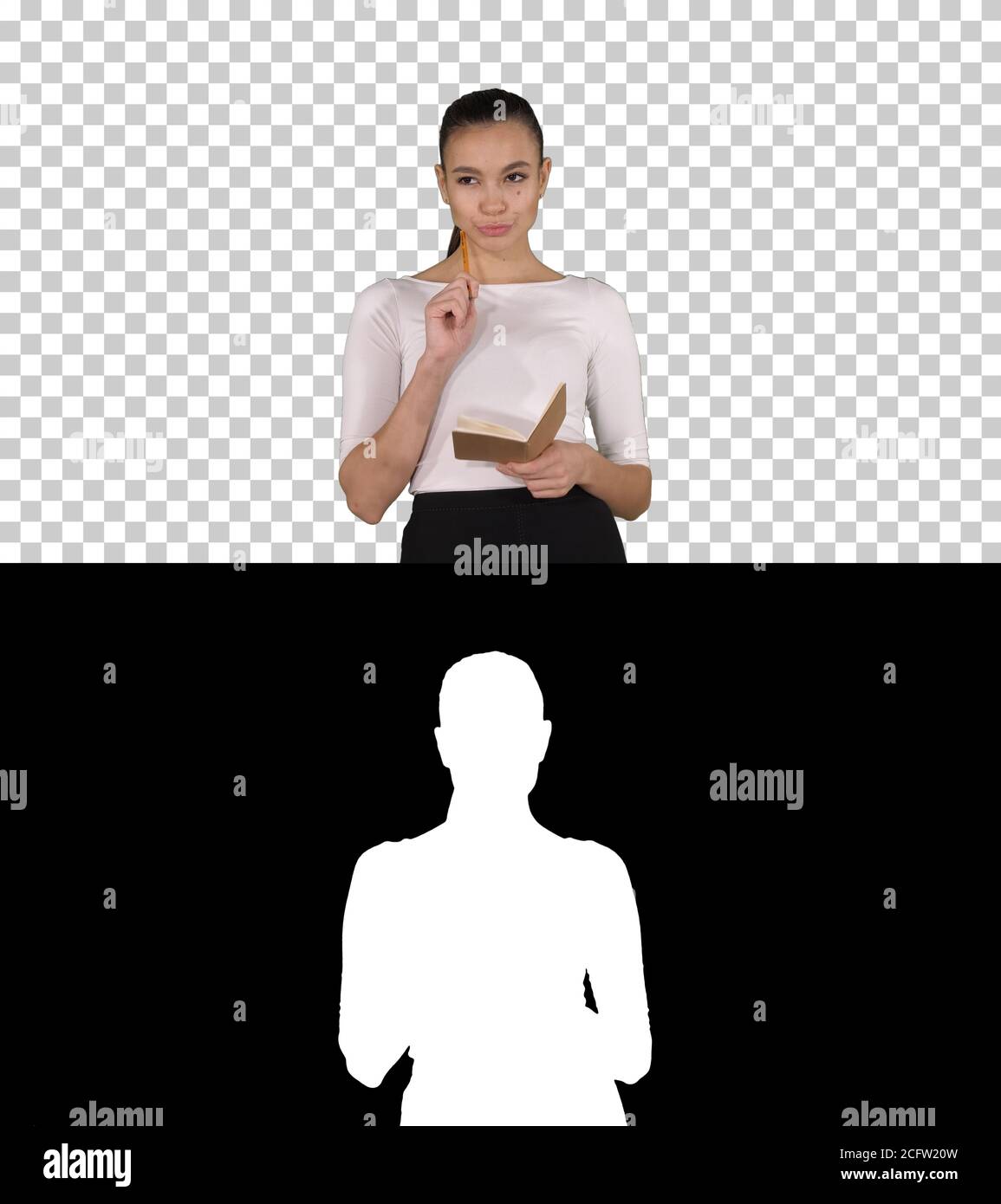 Young woman making notes while walking, Alpha Channel Stock Photo