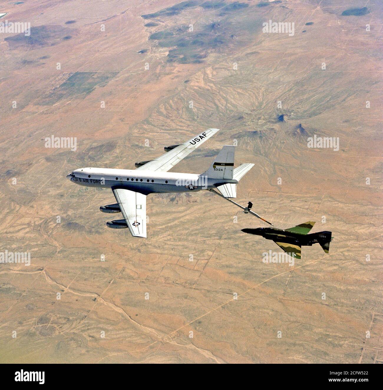 1978 - An air-to-air left side view of an F-4 Phantom II aircraft being refueled by a KC-135A Stratotanker aircraft.  The advanced aerial refueling boom is attached between the two aircraft. Stock Photo