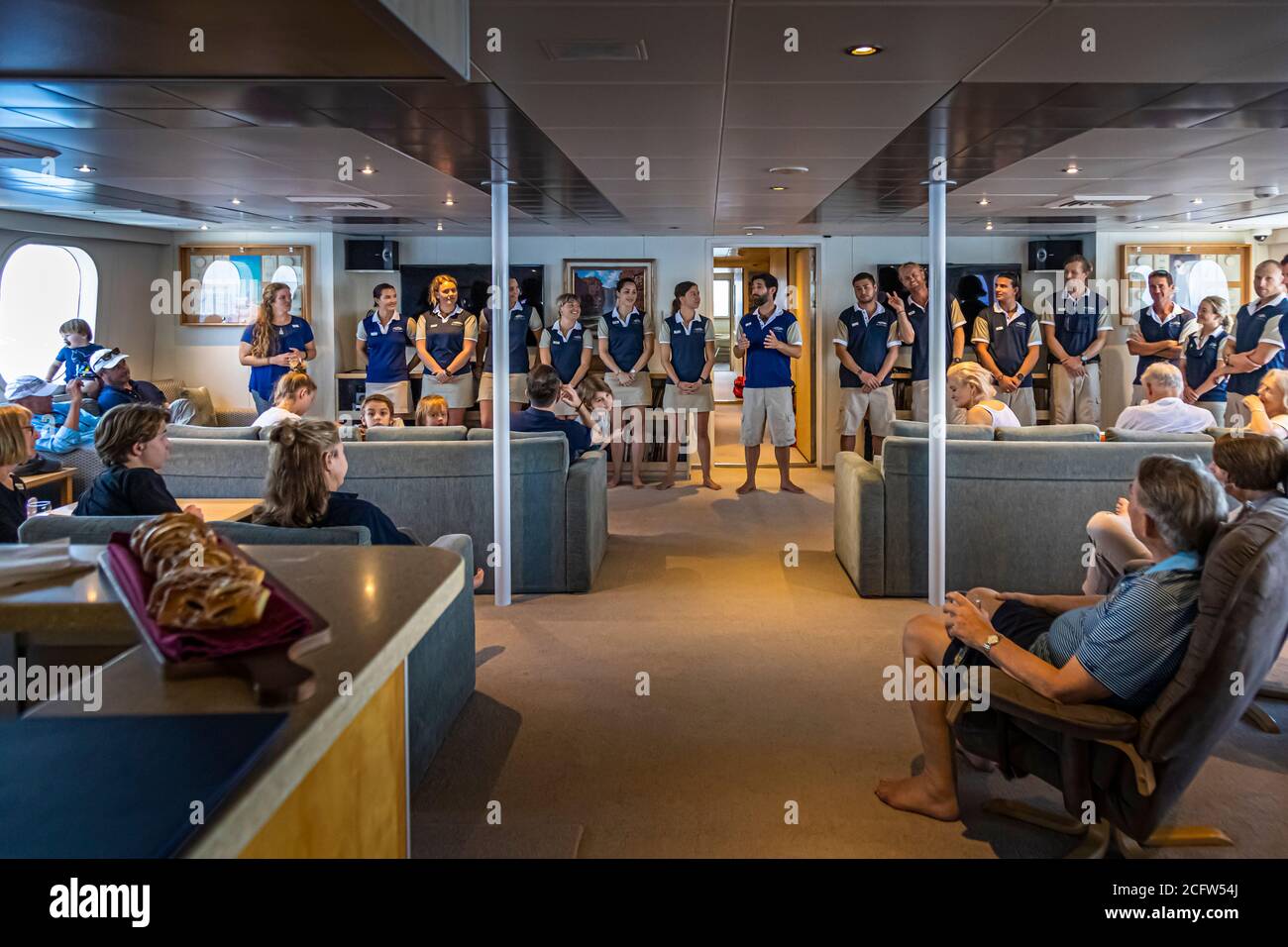 In the spacious bar lounge, Captain Ben Bonnett welcomes the guests and introduces his team. Fire and Dragons Cruise of the True North, Sunda Islands, Indonesia Stock Photo