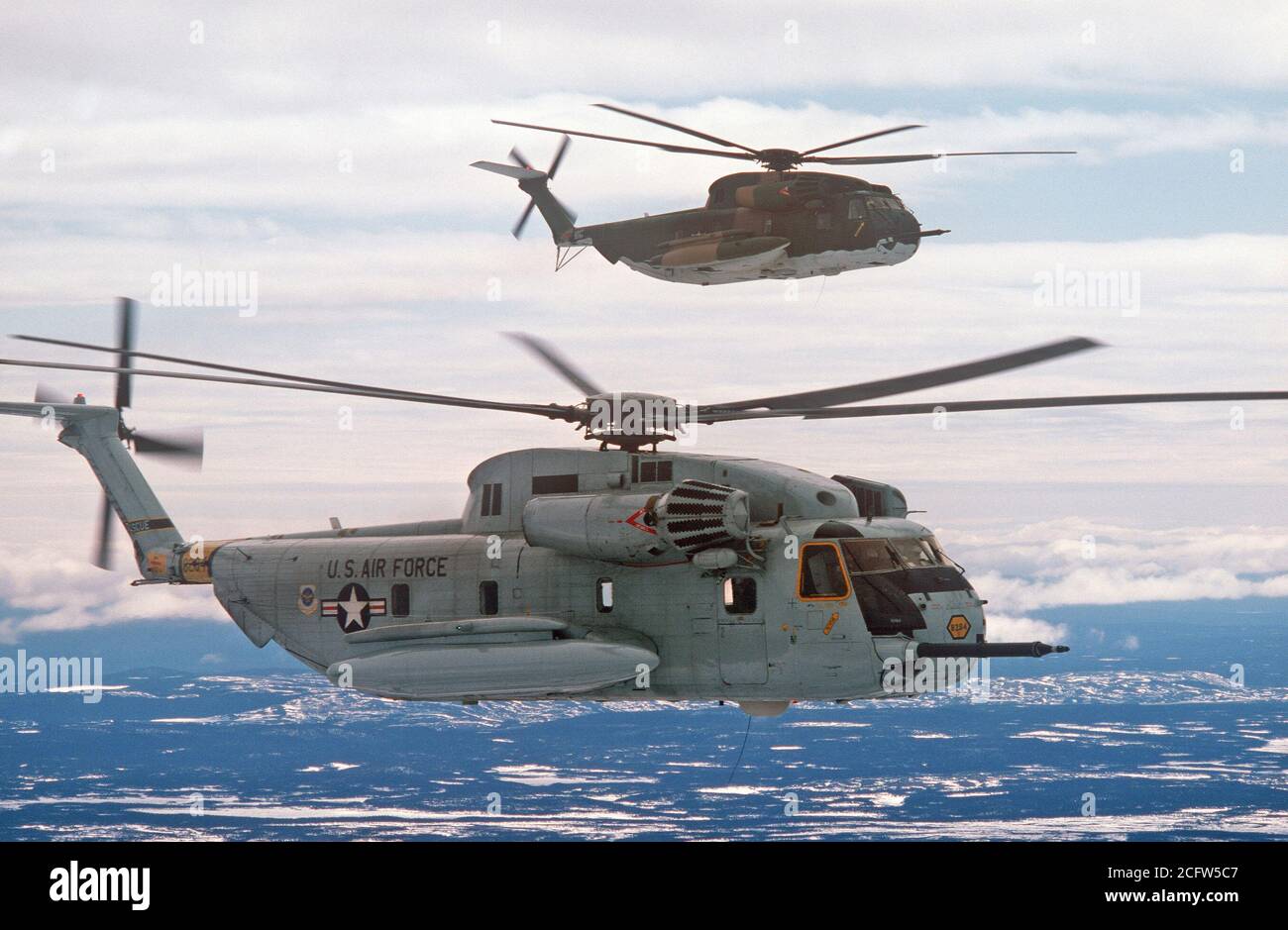 1978 - An air-to-air right side view of two 39th Aerospace Rescue and Recovery Wing HH-53 helicopters over Goose Bay while en route from Eglin Air Force Base, Florida, to Woodbridge, England. Stock Photo