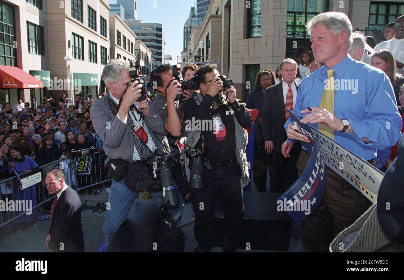 Photograph of President William Jefferson Clinton Being Photographed while Autographing Campaign Posters at a "Get Out the Vote" Rally in Oakland, California 11/3/2000 Stock Photo