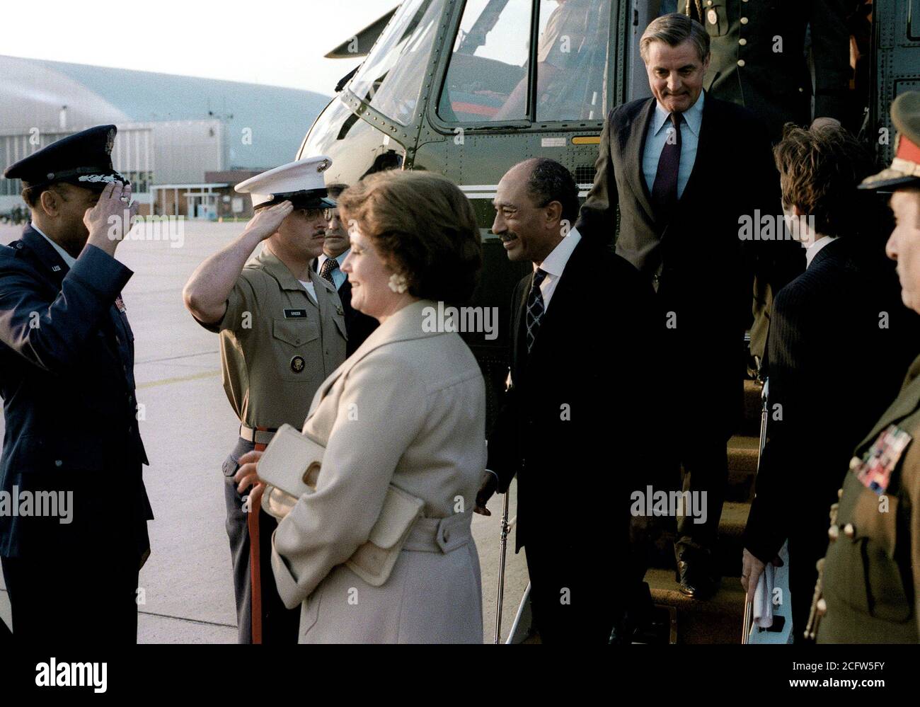 1980 - President and Mrs. Anwar Sadat of Egypt, escorted by Vice President Walter Mondale, arrive at the air terminal prior to their departure from the United States after their visit. Stock Photo