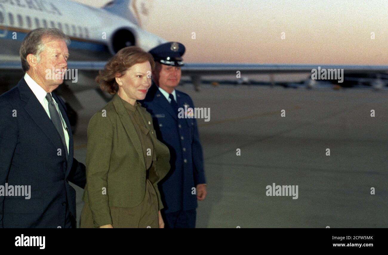 1982 - Former President Jimmy Carter and his wife Rosalynn are escorted to their plane as they prepare to depart for Egypt.  They will attend the funeral for slain Egyptian President Anwar Sadat. Stock Photo