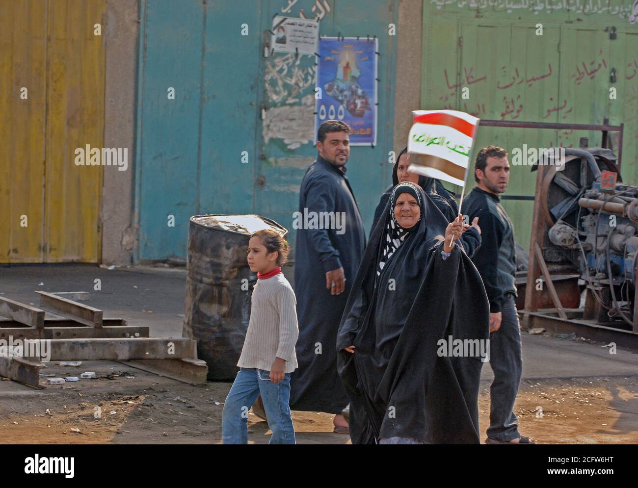 On the streets of Baghdad, Iraq happy citizen blew there horns, cheered, and proudly waved the national flag as they walked through the streets. Stock Photo