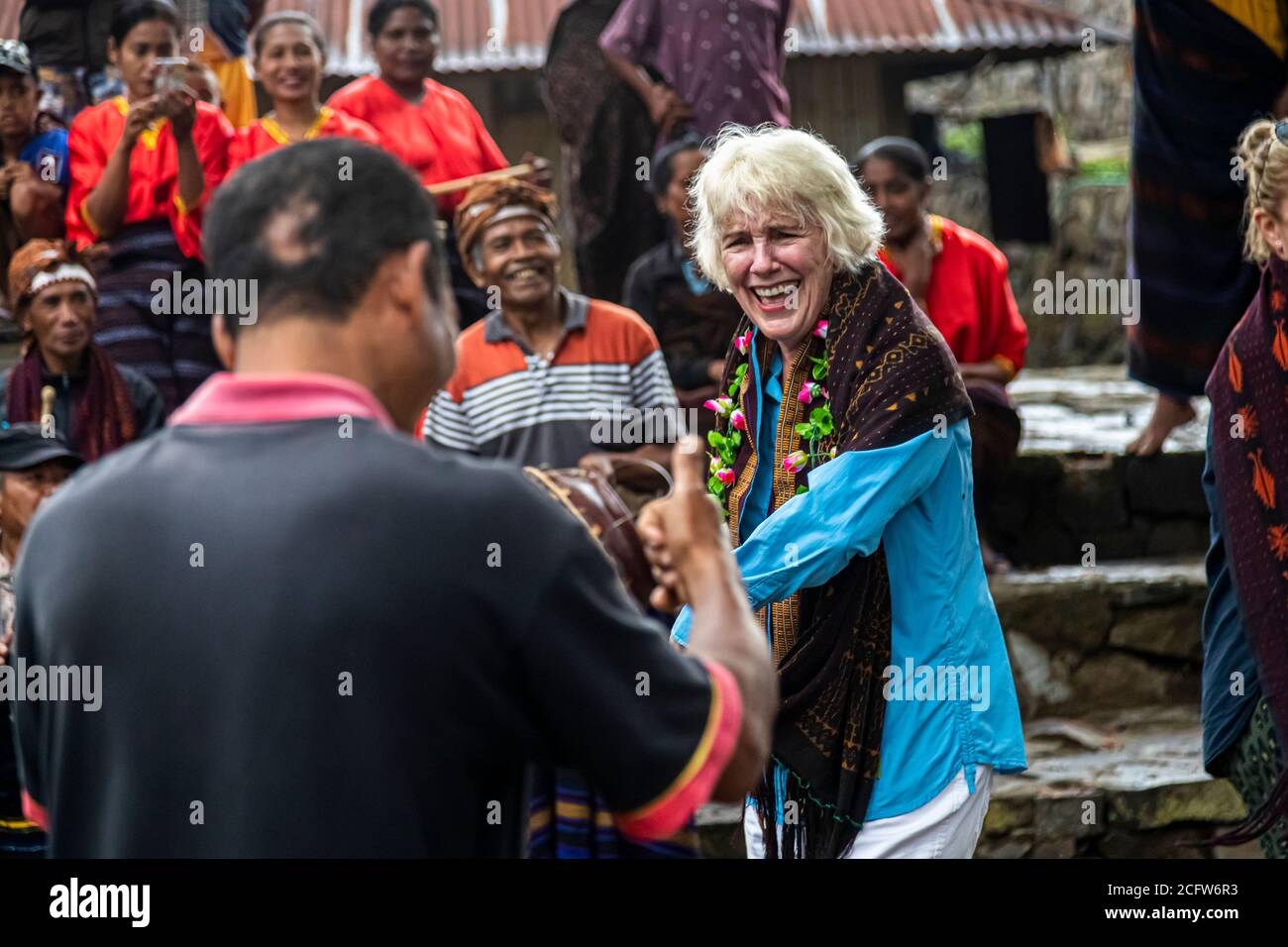 Indonesian People in traditional attire meeting with tourists Stock Photo