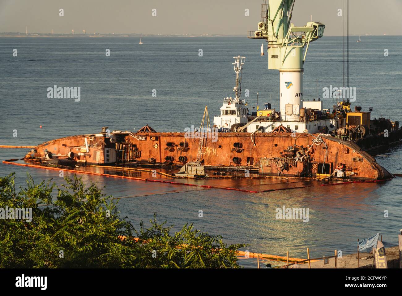 Oil tanker Delphi crashed near Black Sea coast in Ukraine, Odessa 26 August 2020. Small tanker, rusty old, lies on its side in sea. Lifting sunken Stock Photo
