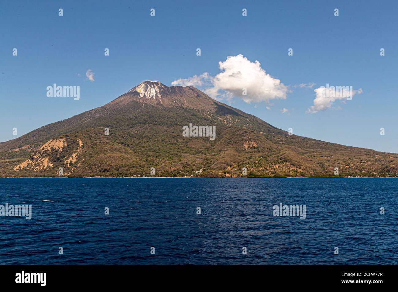 The smell of sulfur from the active Batu Tara volcano on the indonesian island of Pulau Komba can even be smelled in the helicopter Stock Photo