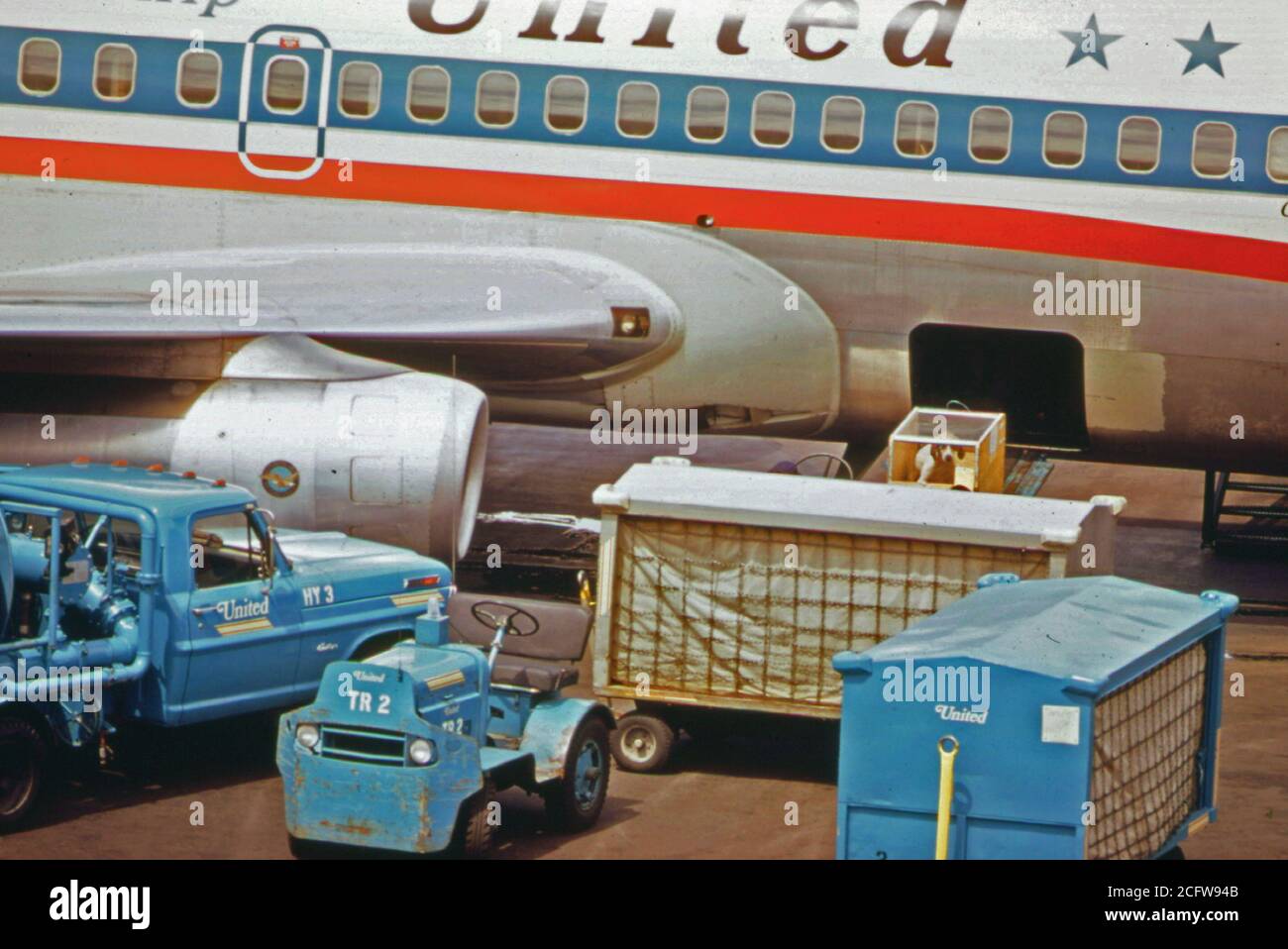 Luggage carts taking luggage to a United Airines Jet Plane at Portland