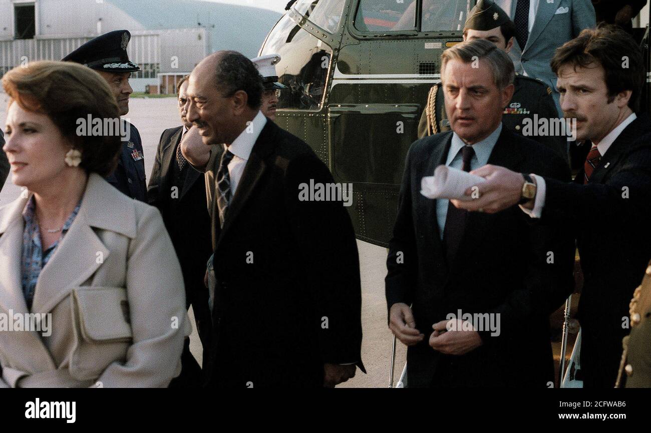 1980 - President and Mrs. Anwar Sadat of Egypt, escorted by Vice President Walter Mondale, arrive at the air terminal prior to their departure from the United States after their visit. Stock Photo