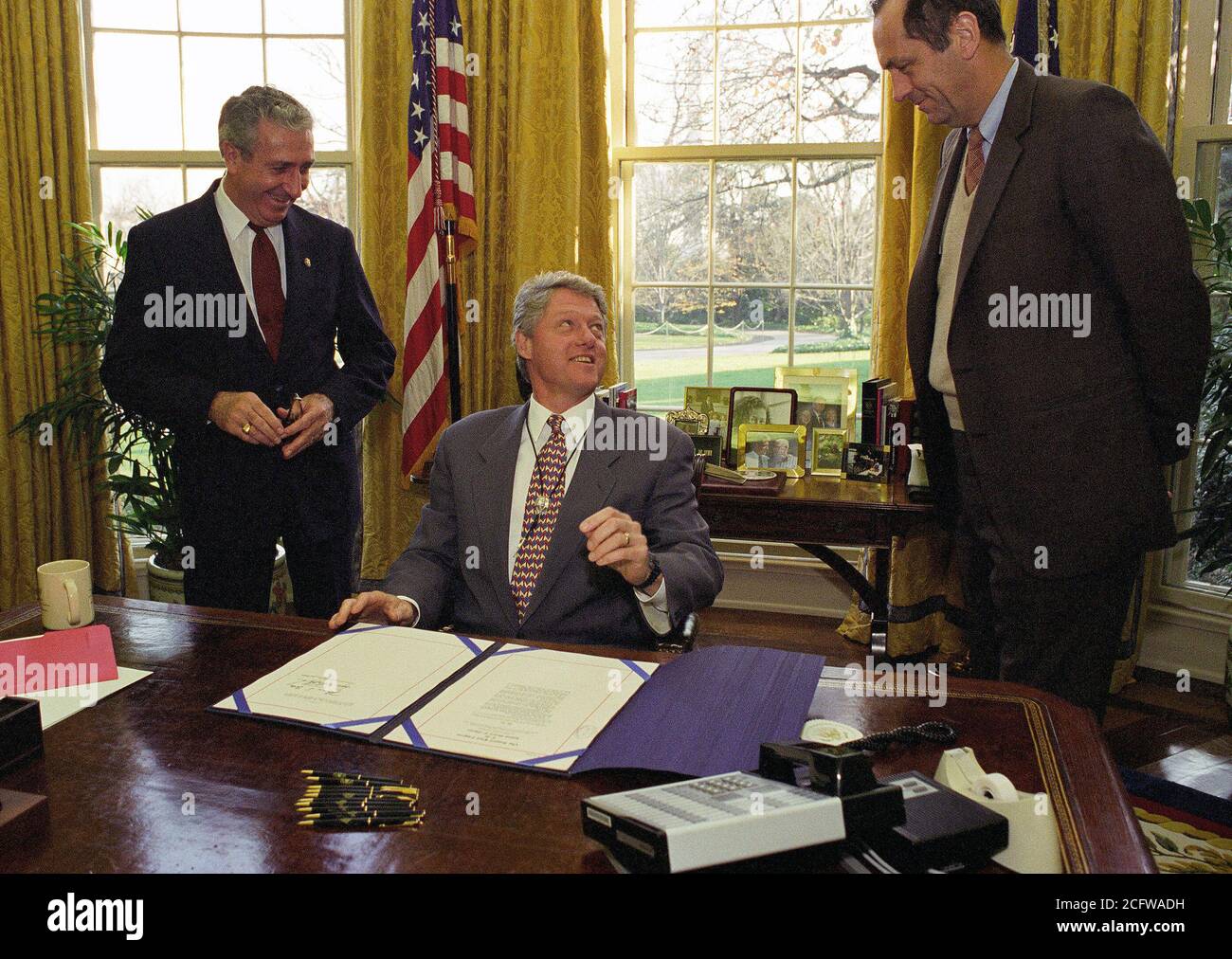 12/1/1993 - Photograph of President William Jefferson Clinton Participating in the Maurice River Bill Signing in the Oval Office at the White House Stock Photo