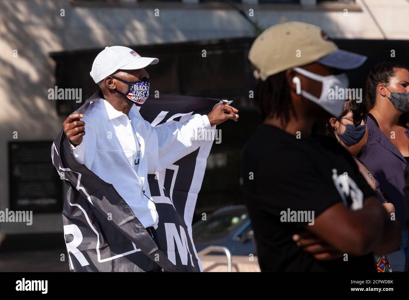 Washington, DC, USA, September 7, 2020. Pictured: A protester displays a Black Lives Matter flag at Let Freedom Sing while enjoying performances by Songrise and the Justice Choir of DC. Let Freedom Sing was a community-building protest and voter registration event by the Freedom Day Foundation and Head Count. Credit: Allison C Bailey/Alamy Credit: Allison Bailey/Alamy Live News Stock Photo
