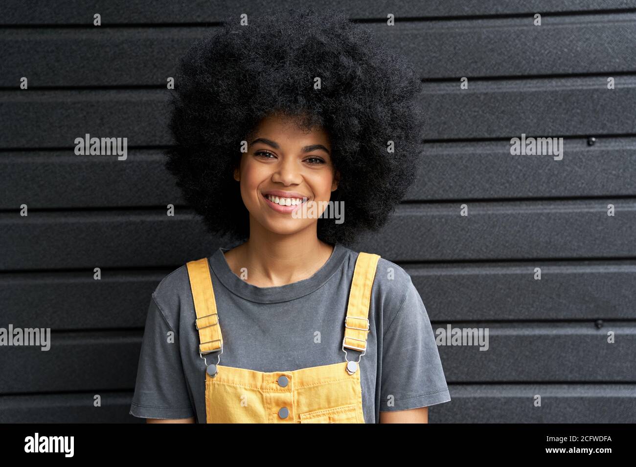 Happy African hipster lady with Afro hair laughing at camera, headshot. Stock Photo