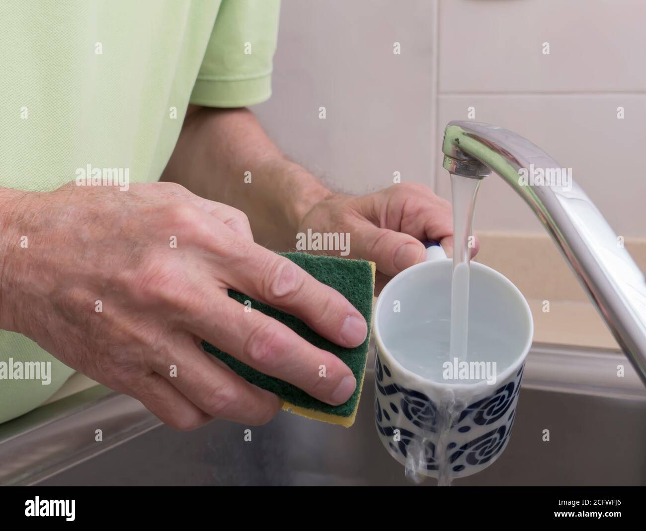 Washing a cup Stock Photo Alamy