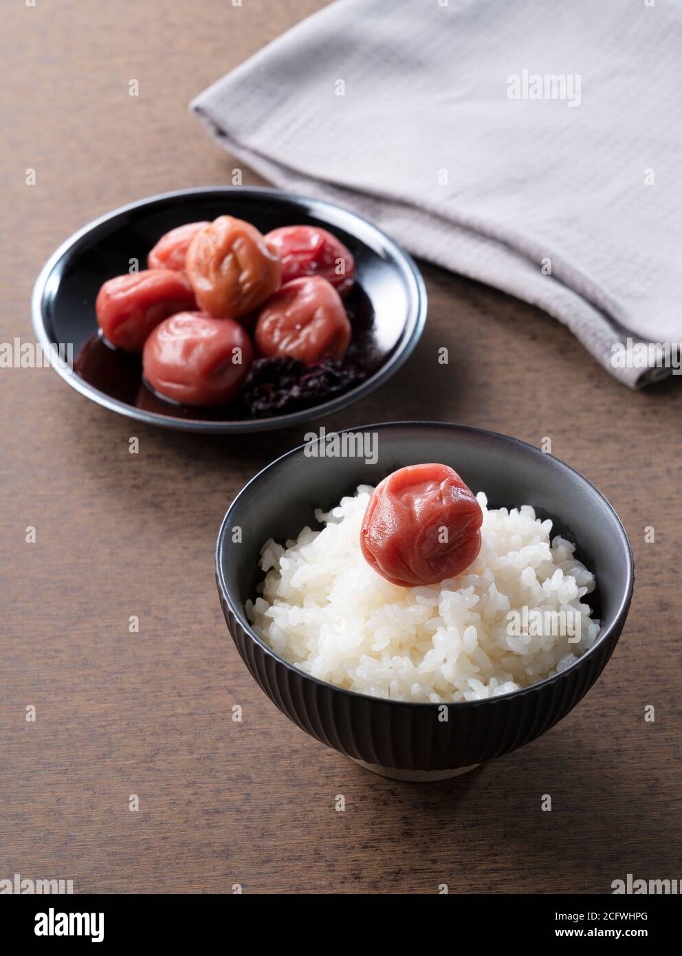 Japanese pickled plum and freshly cooked rice with one pickled plum