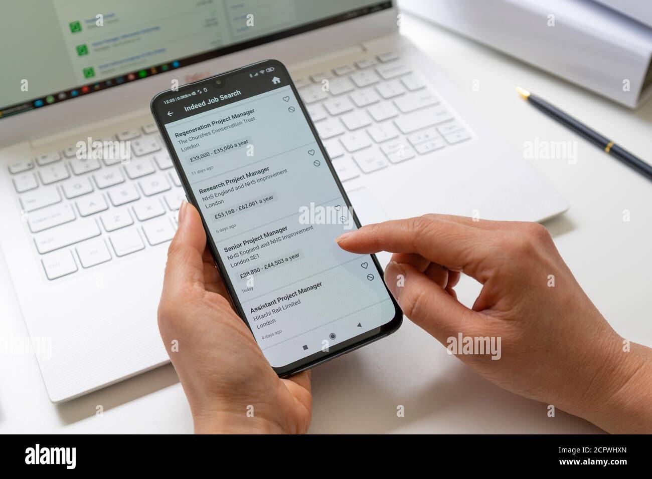 Browsing Job Vacancies In Uk Using Smartphone App Stock Photo Alamy