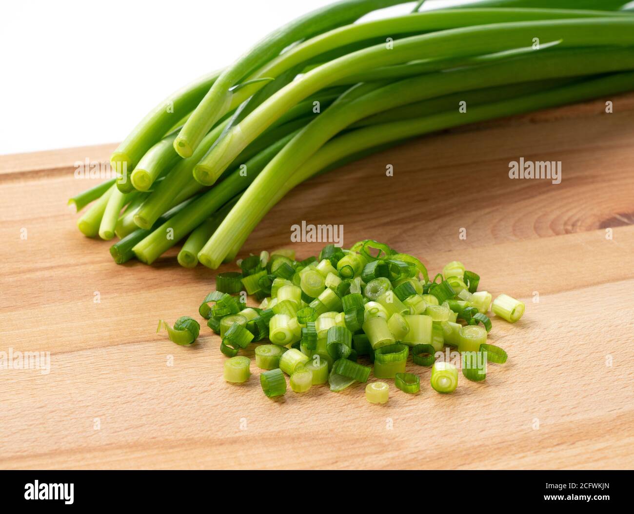 Chopped green onions placed on the cutting board were photographed from ...