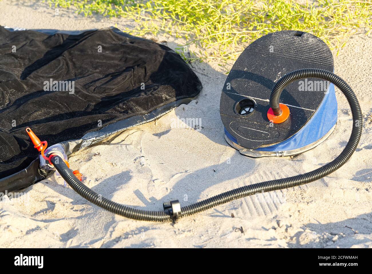 Foot pump near inflatable mattress or air bed at sandy beach. inflates air  mattress with foot pump on sand Stock Photo - Alamy