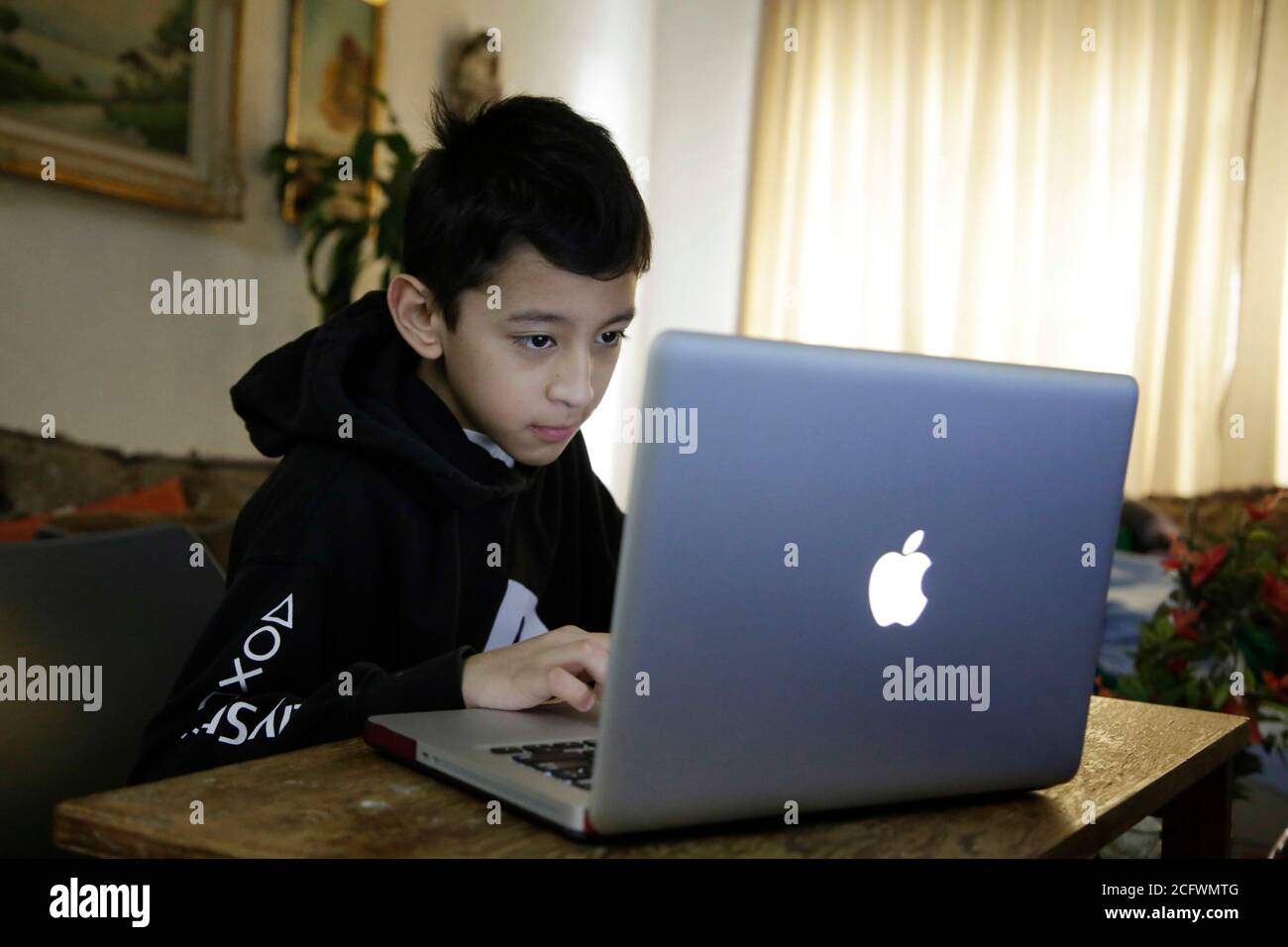 MEXICO CITY, MEXICO - AUGUST 27: A young takes class by the new system of television school. Mexico is broadcasting all school lessons on television This modality of home class continue as attempt  avoid contagion risks, The Coronavirus has already claimed more than 60,000 lives in the country. on August 27, 2020 in Mexico City, Mexico. Credit: Eyepix Group/The Photo Access Stock Photo