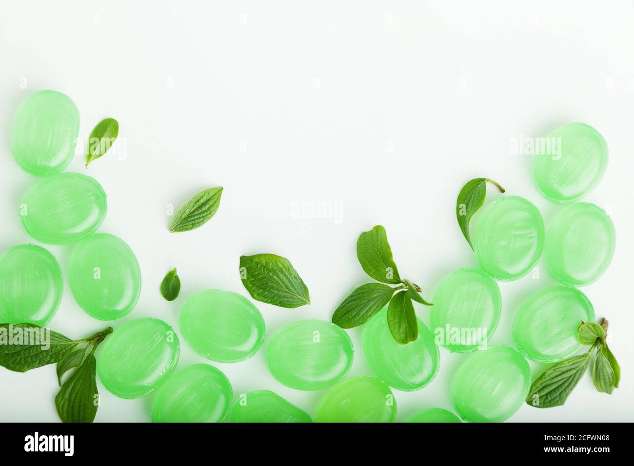 Bunch of cough lozenges with mint green leaves Stock Photo Alamy
