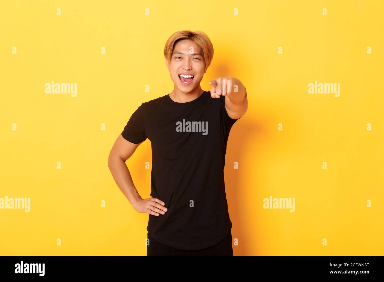 Portrait of cheerful handsome asian guy with blond hair choosing you ...