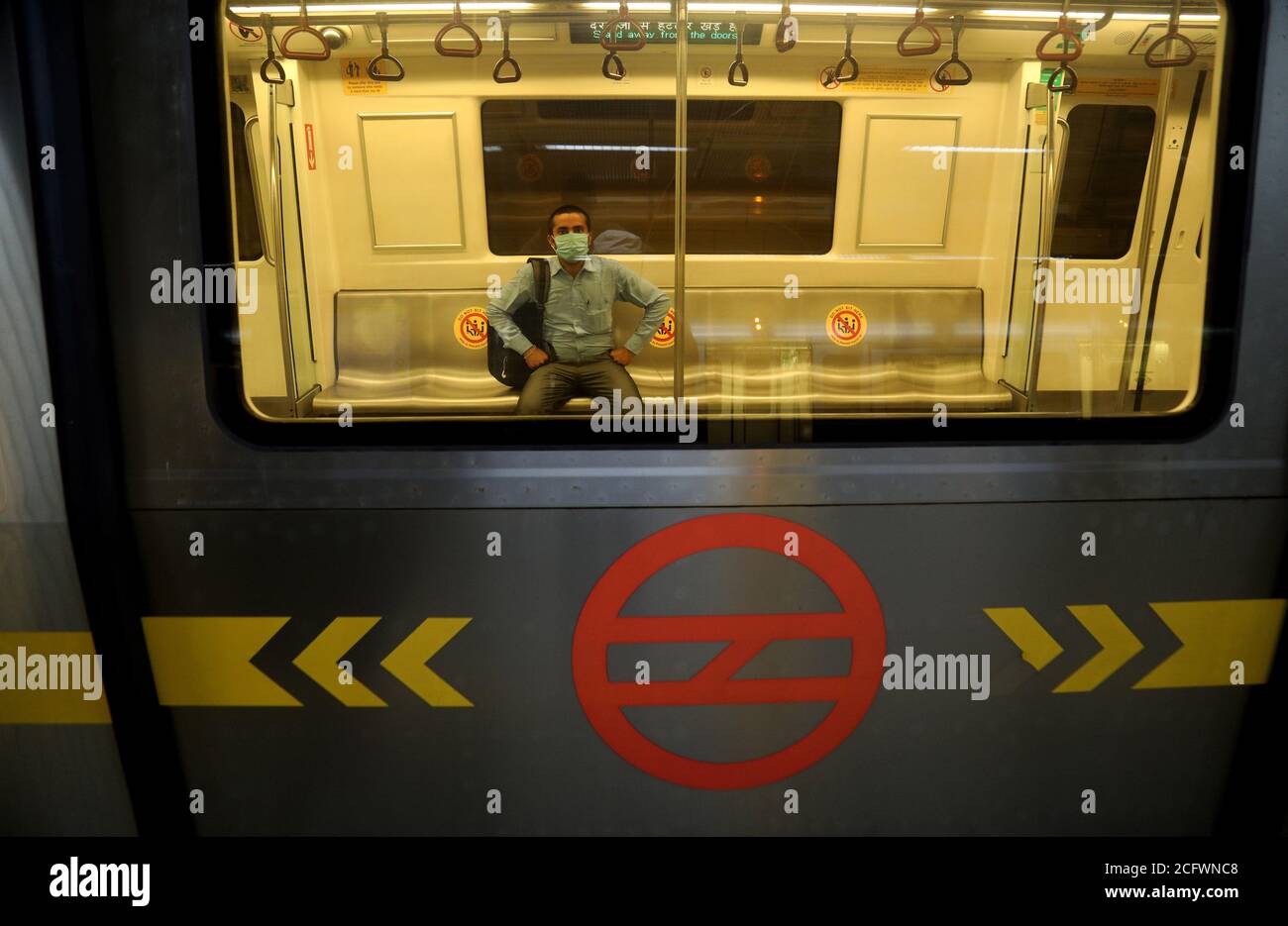 New Delhi, India. 07th Sep, 2020. A man is seen inside Metro while wearing a face mask and observing social distance marks on the first day of reopening after 5 months of lockdown due to Covid-19.On the first day, the yellow line between HUDA City Centre and Samaypur Badli, will run from 7 to 11 am, and 4 to 8 pm in the 2nd phase. The metro will resume full services from September 12. Credit: SOPA Images Limited/Alamy Live News Stock Photo