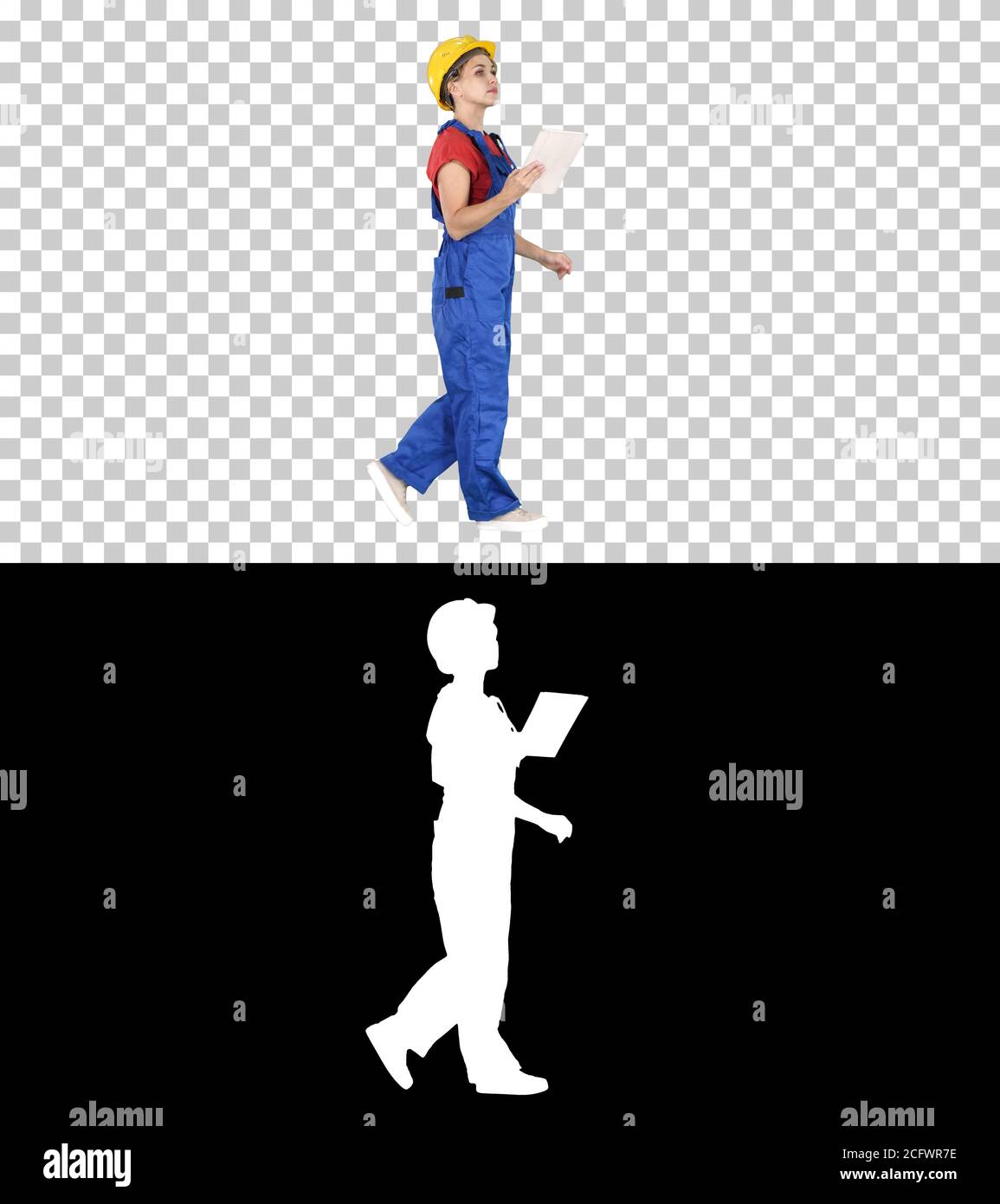 Construction lady using electronic tablet walking, Alpha Channel Stock Photo