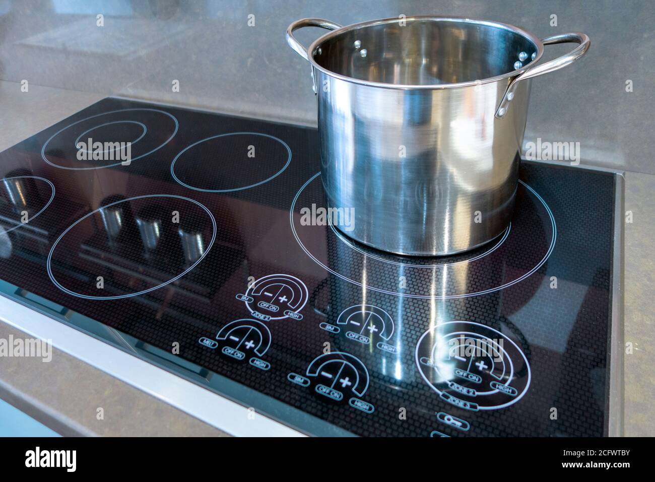 glass electric range top with big stainless steel pot on top of it