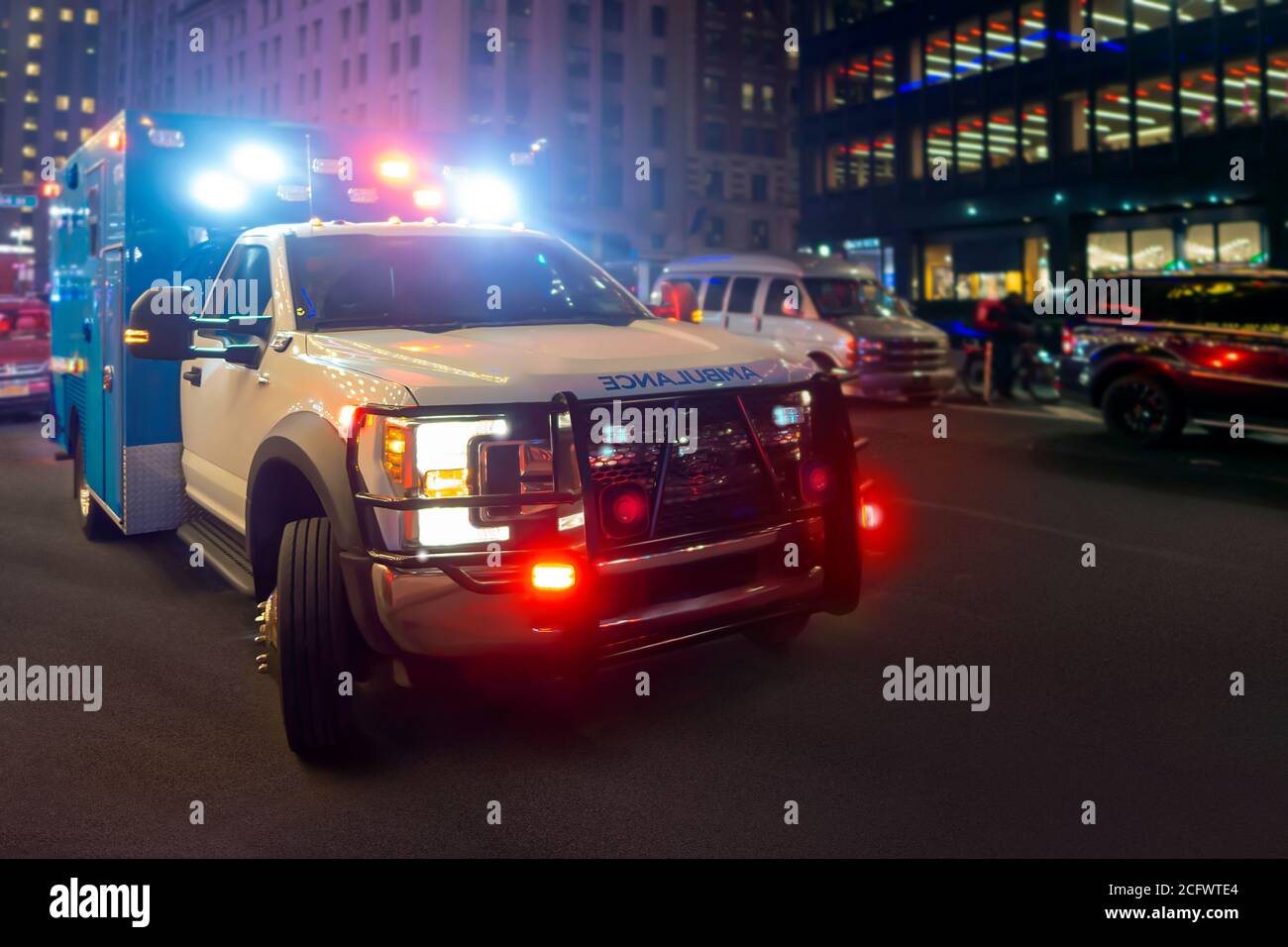 Night ambulance with lights flashing on a new york city street Stock Photo