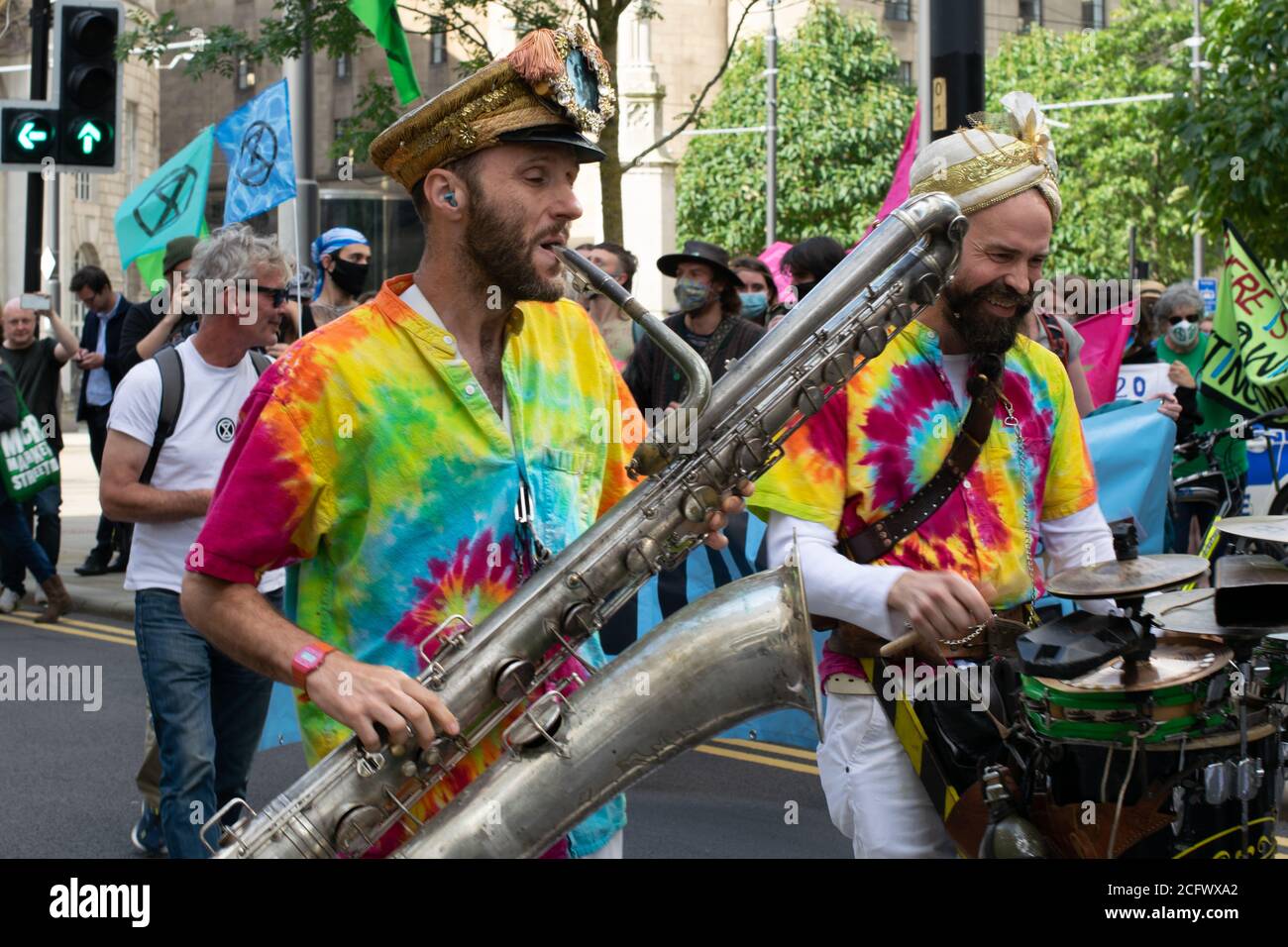 Extinction Rebellion Protest, Manchester,UK.  The quiet rebellion parade led by Mr Wilson's second liners. Saxophone player walking in the parade. Stock Photo