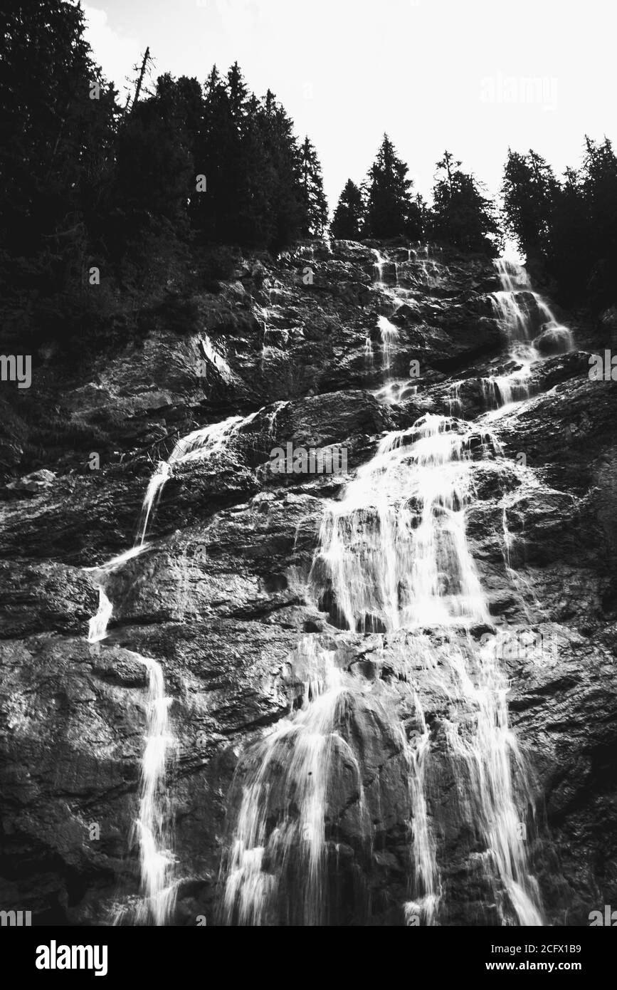 Beautiful Brochaux waterfall in French Alps in summer near Avoriaz  Haute-Savoie, France. Long exposure waterfall shot. Black white photo. Stock Photo