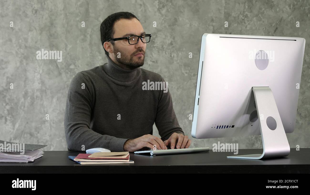 Programming. Man Working On Computer In IT Office, Sitting At Desk Writing Codes. Programmer Typing Data Code, Working On Project In Software Stock Photo