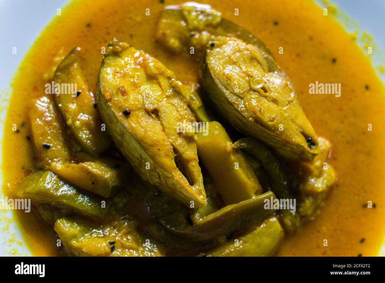 famous Bengali dish hilsha/Ilish with brinjal/Eggplant recipe. Stock Photo