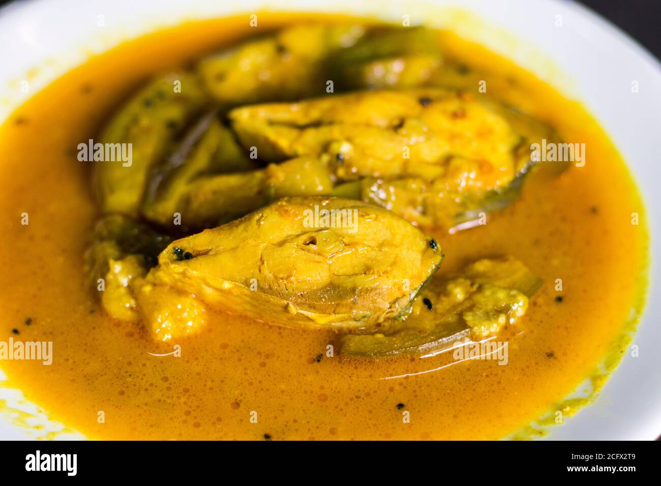 famous Bengali dish hilsha/Ilish with brinjal/Eggplant recipe. Stock Photo