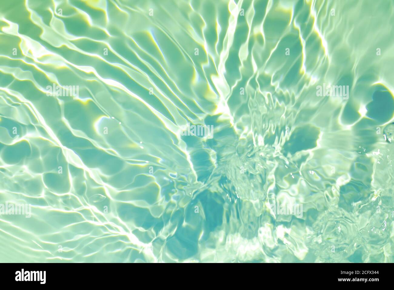 De-focused closeup of mint green transparent clear calm water surface  texture with splashes and bubbles. Trendy abstract summer nature  background. Mint colored waves in sunlight with copy space. Photos